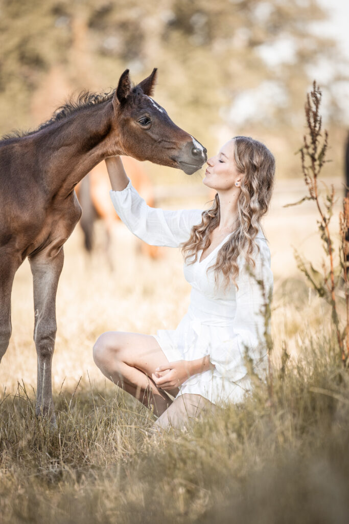 Frau küsst Fohlen bei Pferdefotoshooting mit Coralie Duda Fotografie im Wetteraukreis 3