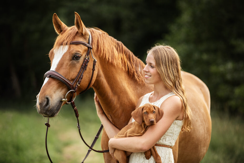 Frau mit Pferd und Welpe bei Fotoshooting im Sommer mit Coralie Duda Fotografie im Wetteraukreis